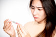 © Varangkana - Asian woman holding pregnancy test feeling disappointed by negative result female health problems and infertility. or unwilling pregnancy, abortion.