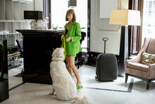 Stylish Business Woman Waits With Her Dog At Reception Of Luxury Hotel. Business Travel And Pet Friendly Service Concept