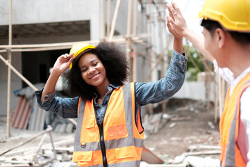 Architect caucasian man working with colleagues mixed race in the construction site. Architecture engineering at workplace. engineer architect wearing safety helmet meeting at contruction site.