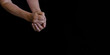 © Natallia - Hands of an elderly woman in wrinkles on a black background close-up