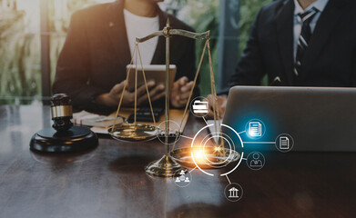 Business and lawyers discussing contract papers with brass scale on desk in office. Law, legal services, advice, justice and law concept picture with film grain effect