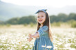 © morrowlight - Smiling cute baby girl 3-4 year old wear stylish dress with flowers in blooming camomile meadow outdoor. Childhood. Summer season.