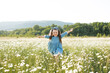 © morrowlight - Happy cheerful child girl 3-4 year old wear stylish rustic dress running in meadow with flowers over nature background. Childhood. Little kid playing in blooming field outside.