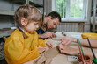 © lithiumphoto - Father and his daughter at a master class in clay modeling