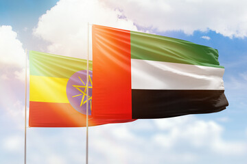 Sunny blue sky and flags of united arab emirates and ethiopia