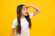 Shocked amazed face, surprised emotions of young teenager girl. Children studio portrait on yellow background. Childhood lifestyle concept. Cute teenage girl face close up.