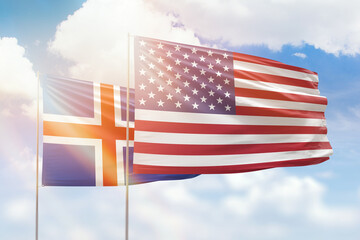 Sunny blue sky and flags of united states of america and iceland