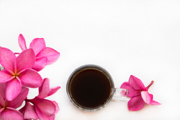 Wall Mural - hot coffee espresso with pink flowers frangipani arrangement flat lay postcard style on background white 