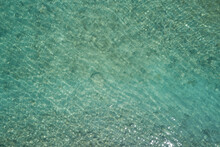 Clear Water Top. Turquoise Blurred Water Top View. Stones At The Bottom Of The Water Aerial View.