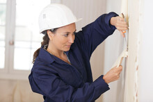 A Woman Removing Wall Paper