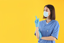 Concept Of Profession, Young Female Doctor On Yellow Background