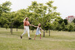 © Rabizo Anatolii - Mom and daughter run in the park and have fun. Family values and traditions. Happy childhood of a child. Mother plays with her daughter.