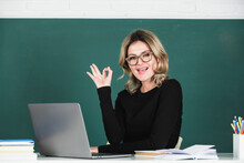 Portrait Of Funny Amazed Teacher Teaching Line Of High School Students With Computer Laptop In Classroom On Blackboard.