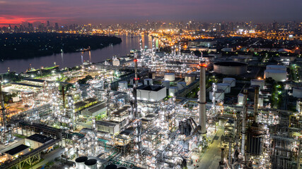 Wall Mural - Oil and gas refinery plant form industry zone at night, Aerial view oil and gas Industrial petrochemical fuel power and energy.