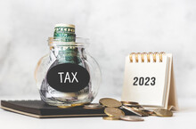 Tax Time In 2023. Glass Money Box With Money