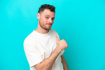 Wall Mural - Young Brazilian man isolated on blue background proud and self-satisfied