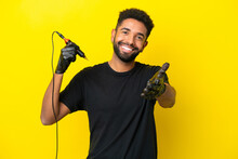 Tattoo Artist Man Brazilian Man Isolated On Yellow Background Shaking Hands For Closing A Good Deal