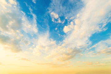 Wall Mural - Sky blue and orange light of the sun through the clouds in the sky