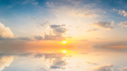 Wall Mural - Sky blue and orange light of the sun through the clouds in the sky