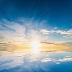 Wall Mural - Sky blue and orange light of the sun through the clouds in the sky