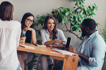 Canvas Print - Photo of group positive students point finger netbook communicate discuss project startup indoors