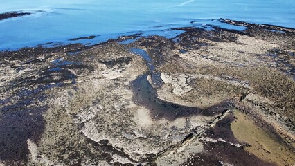 Canvas Print - Aerial view of the incredible coastline of Scotland with views of the North Sea. Blue sky background with ocean waves. 