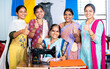 Woman with trainers around showing thumbs up by looking at camera while learning tailoring at class - concept of woman empowerment, growth and development.