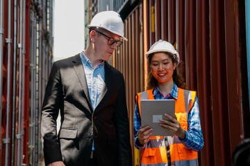 Manager and container worker working in the construction container yard.