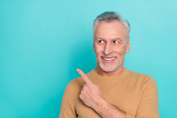 Sticker - Portrait of satisfied aged man look direct finger empty space proposition isolated on turquoise color background