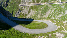 San Gottardo, Switzerland. Amazing View Of The Bends Of The Pave Road Leading To The Mountain Pass. Grand Tour. Historical Route