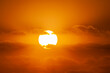 © Tetra Images - Sun with orange clouds in sunset sky