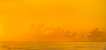Golden Sunrise Clouds Over Calm Ocean