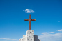 USA, New Mexico, Golden, Simple Wooden Cross Against Sky