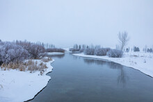 USA, Idaho, Bellevue, Calm River Crossing Snow Covered Landscape
