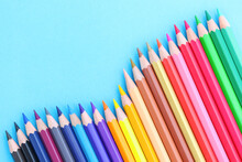 Colored Pencils With Copy Space On Blue Background Educational Concept