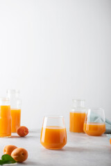 Poster - Summer apricot juice on the light background