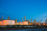 Fototapeta Kwiaty - Oil​ refinery​ plant and tower column of Petrochemistry industry in tank oil​ and​ gas​ ​industrial with​ cloud​ blue​ ​sky