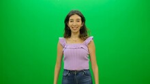 Woman In A Casual Lilac Top And Jeans Gesturing A Thumbs Up Sign - Green Screen