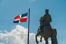 Closeup Shot Of The General Gregorio Luperon Statue And The Flag Of Dominican Republic