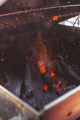 Poster - Closeup shot of charcoal with sparks and fire coming out of the coal