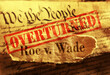 © zimmytws - Roe V Wade newspaper headline with Overturned stamp on the United States Constitution