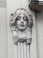 Wall Mural - Woman face sculpture on a wall