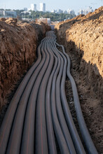 Digital Telecommunication Network Cables Are Laid Towards The City. Cables In Friction Reduced Pipe Are Buried Underground. A Large Number Of Electric And High-speed Network Cables Construction Site
