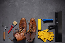 Old Leather Boots And Construction Work Tools On Floor Background Texture. Renovation Concept
