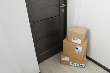 Canvas Print - Cardboard boxes on floor near entrance. Parcel delivery service