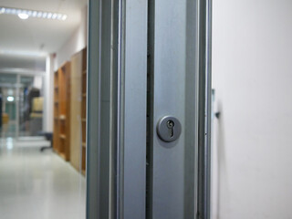 closeup of metal handles with glass door in the office.	
