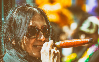 Wall Mural - Happy smiling woman pretending to smoke cigar in Mardi Gras Carnival Parade, New Orleans.