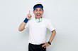© Bangun Stock Photo - Excited young Asian sportman in blue headband and sportswear white t-shirt with headphones, pointing fingers up having a good idea isolated on white background. Workout sport concept