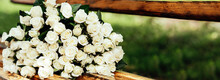 Close-up Of A Huge Bouquet Of White Roses On Wooden Bench. Background Of The Many Roses Wedding, The Day Of St. Valentine. Copy Space