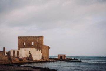 Wall Mural - East Coast of Sicily in Italy, Europe on a warm spring day at the coast with old structures